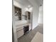 Elegant wet bar area featuring glass cabinets, a wine cooler, and countertop at 13406 Chenille Dr, Port Charlotte, FL 33981