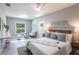 Bright bedroom featuring a ceiling fan, and an eclectic mix of furniture and textures at 14372 Tugwell Ave, Port Charlotte, FL 33953