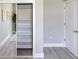 Neutral bedroom with closet organizer featuring shelving, light-colored floor, and painted walls at 14372 Tugwell Ave, Port Charlotte, FL 33953