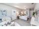 Well-lit bedroom featuring a ceiling fan, eclectic mix of furniture, decor and bright light at 14372 Tugwell Ave, Port Charlotte, FL 33953