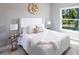 Stylishly furnished bedroom featuring a large window with natural light and neutral tones at 14372 Tugwell Ave, Port Charlotte, FL 33953