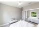 A clean and modern bedroom with a mirrored closet and view of the yard through the window at 14372 Tugwell Ave, Port Charlotte, FL 33953