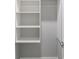 An organized closet space with white shelving to easily store clothing and accessories at 14372 Tugwell Ave, Port Charlotte, FL 33953