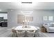 Bright dining room with linear lighting, light gray walls, seating for six, and plank floors at 14372 Tugwell Ave, Port Charlotte, FL 33953