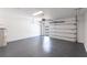Spacious two-car garage with epoxy floor, modern door, and ample room for vehicles at 14372 Tugwell Ave, Port Charlotte, FL 33953