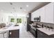 Modern kitchen featuring sleek cabinetry, stainless steel appliances, a large island, and an open layout at 14372 Tugwell Ave, Port Charlotte, FL 33953