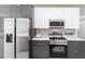 Contemporary kitchen with stainless steel appliances, custom cabinetry, and white countertops at 14372 Tugwell Ave, Port Charlotte, FL 33953