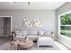 Comfortable living room featuring stylish decor, natural light, and a view of the outdoors from the large window at 14372 Tugwell Ave, Port Charlotte, FL 33953
