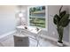 Well-lit home office featuring natural light, neutral decor, and minimalist design at 14372 Tugwell Ave, Port Charlotte, FL 33953