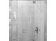Bright shower featuring clear glass surround and white marble-style tiling at 14372 Tugwell Ave, Port Charlotte, FL 33953