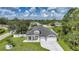 An elevated perspective of a beautiful house displaying its manicured lawn and architectural details at 1523 Napoleon Rd, North Port, FL 34288