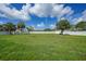 Large backyard with lush lawn and a white privacy fence at 1523 Napoleon Rd, North Port, FL 34288