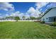 Large fenced backyard with green lawn and landscaping providing a secure and private outdoor space at 1523 Napoleon Rd, North Port, FL 34288