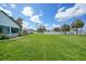 Spacious backyard featuring lush green grass and a white fence, perfect for outdoor activities and privacy at 1523 Napoleon Rd, North Port, FL 34288