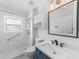 Well-lit bathroom with a walk-in shower, modern fixtures, and ample storage at 1523 Napoleon Rd, North Port, FL 34288