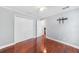 Bedroom featuring wood floors, ceiling fan and closet with a view of the bathroom at 1523 Napoleon Rd, North Port, FL 34288