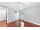Bedroom with wood floors and a window providing ample natural light at 1523 Napoleon Rd, North Port, FL 34288