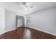 Well-lit bedroom with wood floors, closet, ceiling fan, and natural light at 1523 Napoleon Rd, North Port, FL 34288