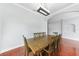Dining room with hardwood floors, large windows, and a modern chandelier at 1523 Napoleon Rd, North Port, FL 34288