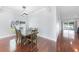 Dining room with hardwood floors, large windows, and a modern chandelier at 1523 Napoleon Rd, North Port, FL 34288
