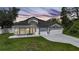 Home exterior displaying fresh paint and a meticulously kept lawn, captured in the evening light at 1523 Napoleon Rd, North Port, FL 34288