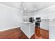 Kitchen features white cabinetry, stainless steel appliances, and an island with bar seating at 1523 Napoleon Rd, North Port, FL 34288