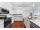 Bright kitchen with stainless steel appliances and white cabinetry at 1523 Napoleon Rd, North Port, FL 34288