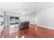 Spacious living room with hardwood floors, fireplace, and access to the backyard pool at 1523 Napoleon Rd, North Port, FL 34288