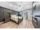 Spacious main bedroom features an electric fireplace, wood accent wall and ceiling fan at 1523 Napoleon Rd, North Port, FL 34288