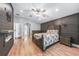 Bedroom featuring decorative accent wall with electric fireplace and en-suite bathroom at 1523 Napoleon Rd, North Port, FL 34288