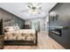 Spacious main bedroom featuring an electric fireplace, wood accent wall, ceiling fan at 1523 Napoleon Rd, North Port, FL 34288