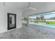 Covered patio with tiled floors, ceiling fan, and view of the sparkling pool and backyard at 1523 Napoleon Rd, North Port, FL 34288