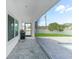 Covered patio featuring tiled floor, a built in grill, and a view of the pool and backyard at 1523 Napoleon Rd, North Port, FL 34288