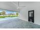Covered patio with tiled floors, ceiling fan, and access to backyard pool at 1523 Napoleon Rd, North Port, FL 34288