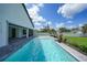 Backyard pool with a paved patio area, lush landscaping, and a privacy fence at 1523 Napoleon Rd, North Port, FL 34288