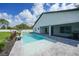 Backyard pool with a paved patio area, lush landscaping, and a privacy fence at 1523 Napoleon Rd, North Port, FL 34288
