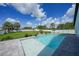 Backyard pool with a paved patio area, lush landscaping, and a privacy fence at 1523 Napoleon Rd, North Port, FL 34288
