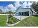 Backyard showcasing a sparkling pool with beautiful landscaping and a covered patio for outdoor entertaining at 1523 Napoleon Rd, North Port, FL 34288