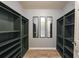 Spacious walk-in closet with shelving and ample storage space, with three mirrors at 1523 Napoleon Rd, North Port, FL 34288