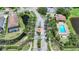 Aerial view of a gated community entrance, swimming pool, and lush tropical landscaping at 15261 Mille Fiore Blvd, Port Charlotte, FL 33953