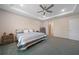Relaxing bedroom with a tray ceiling, a ceiling fan, and neutral-colored walls at 15261 Mille Fiore Blvd, Port Charlotte, FL 33953