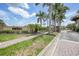 Gated community entrance with mature landscaping, brick walkways, and signage at 15261 Mille Fiore Blvd, Port Charlotte, FL 33953