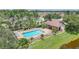 Community swimming pool featuring sun loungers, shade, and a fenced perimeter for safety at 15261 Mille Fiore Blvd, Port Charlotte, FL 33953