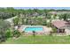 Community swimming pool with sun loungers and seating surrounded by palm trees at 15261 Mille Fiore Blvd, Port Charlotte, FL 33953