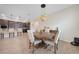 Bright dining area with wood floors, a round table with seating for four, and stylish pendant lighting at 15261 Mille Fiore Blvd, Port Charlotte, FL 33953