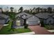 Charming single-Gathering home featuring stone accents, a two-car garage, and a well-manicured lawn at 15261 Mille Fiore Blvd, Port Charlotte, FL 33953