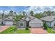 Beautiful single-Gathering home featuring stone accents, a two-car garage, and a lush green lawn at 15261 Mille Fiore Blvd, Port Charlotte, FL 33953