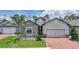 Charming single-Gathering home featuring stone accents, a two-car garage, and a well-manicured lawn at 15261 Mille Fiore Blvd, Port Charlotte, FL 33953