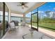 Comfortable screened lanai offers a relaxing outdoor space with a ceiling fan, furniture and views of the fenced backyard at 15261 Mille Fiore Blvd, Port Charlotte, FL 33953