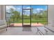 View from lanai to fenced yard with a combination of a tile and brick patio that allows seamless indoor/outdoor living at 15261 Mille Fiore Blvd, Port Charlotte, FL 33953